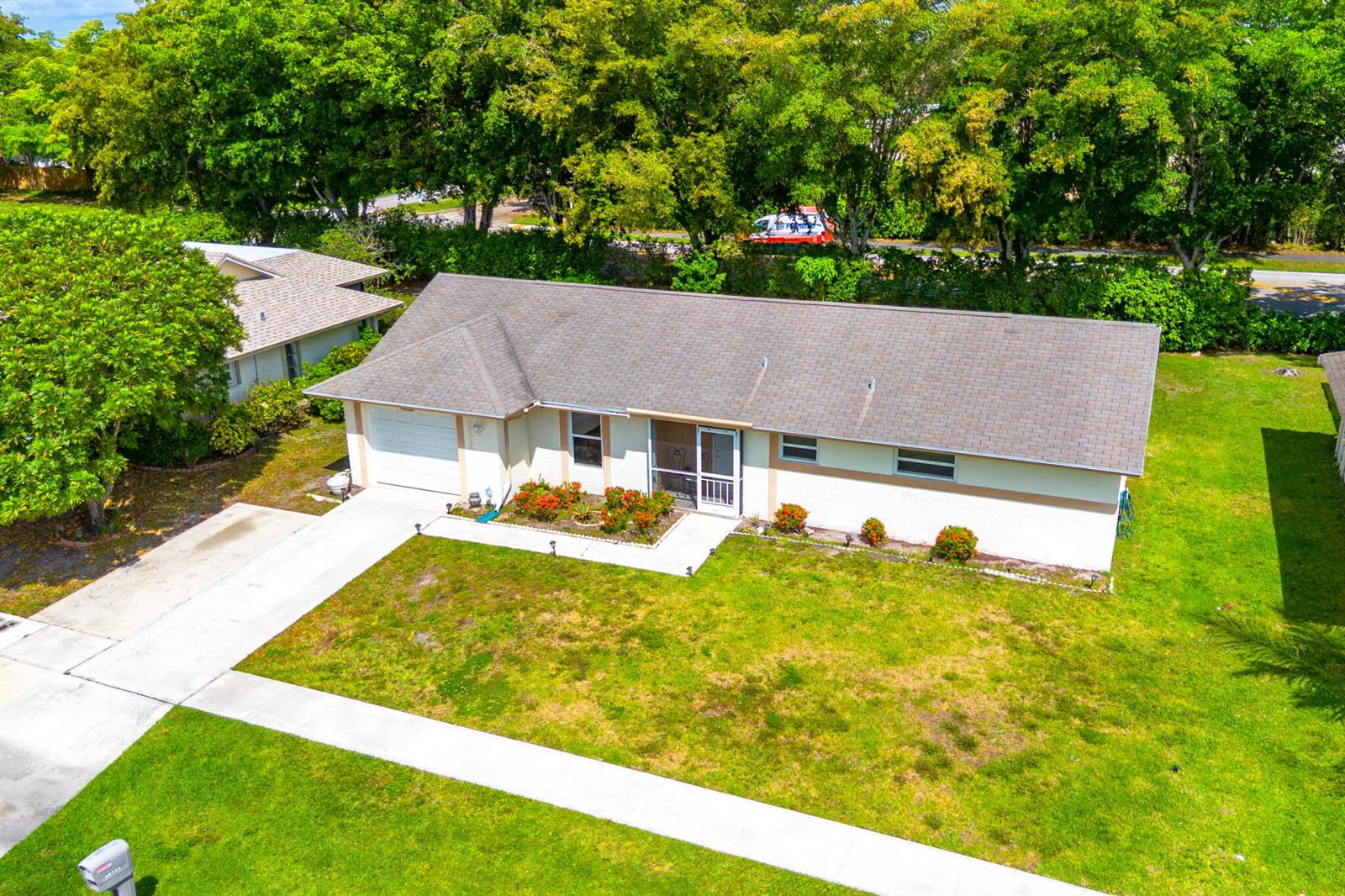 An aerial view of a single-story house with a shingled roof and a concrete driveway — 14759 Hideaway Lane, Delray Beach FL 33484, DELRAY BEACH, FL