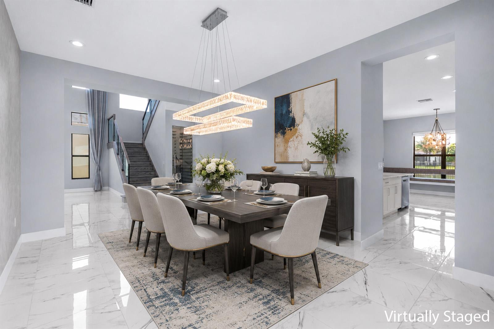 A bright foyer features marble tile floors, a glass-enclosed wine cellar, and a wooden staircase — 17411 Sea Blossom Way, Boca Raton FL 33496, BOCA RATON, FL