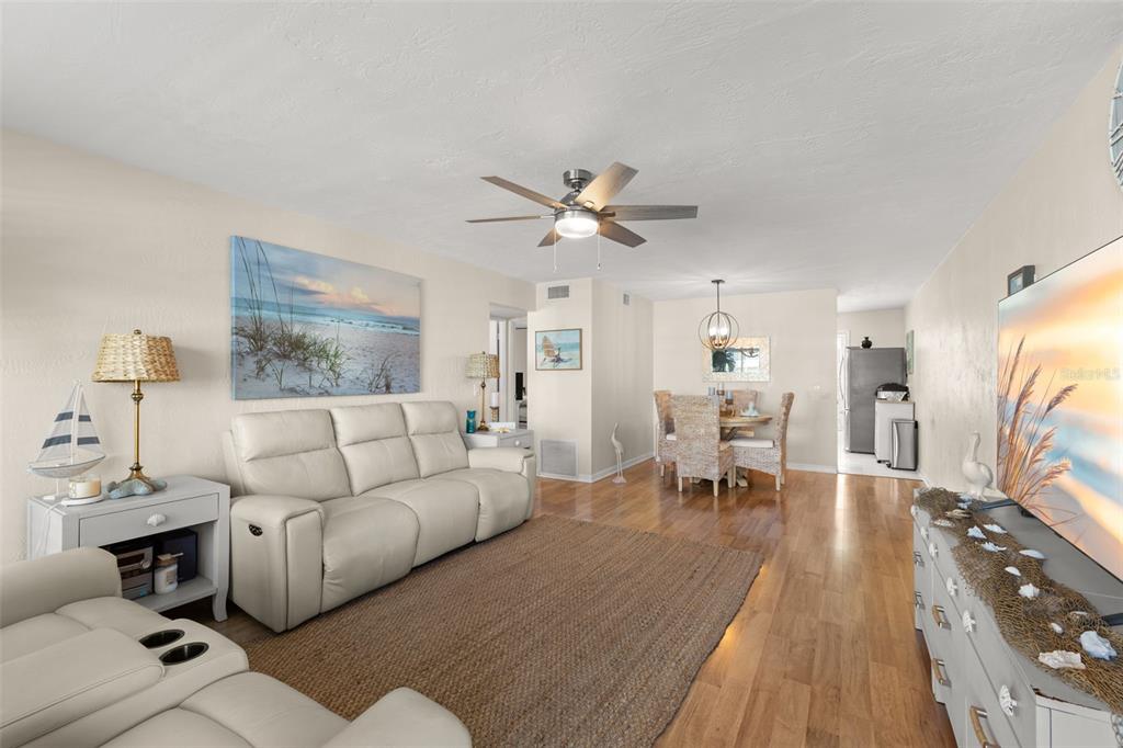 A kitchen with wood cabinets and butcher block countertops features a washer next to the dishwasher — 2461 CANADIAN WAY UNIT 27, CLEARWATER, FL