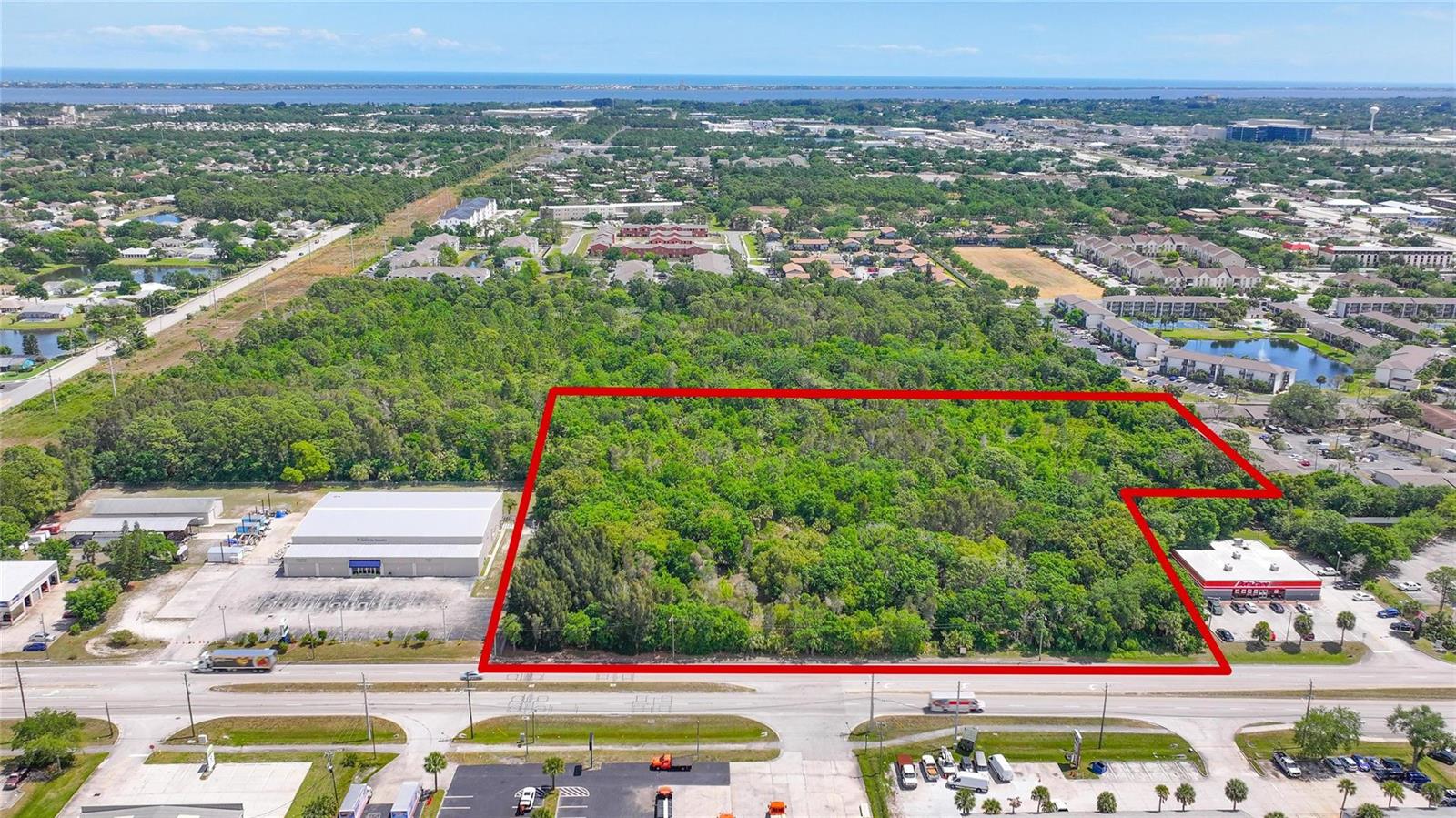 An aerial view shows a large, rectangular, wooded plot of land outlined in red — 4527 S Babcock Street, Palm Bay FL 32905, PALM BAY, FL