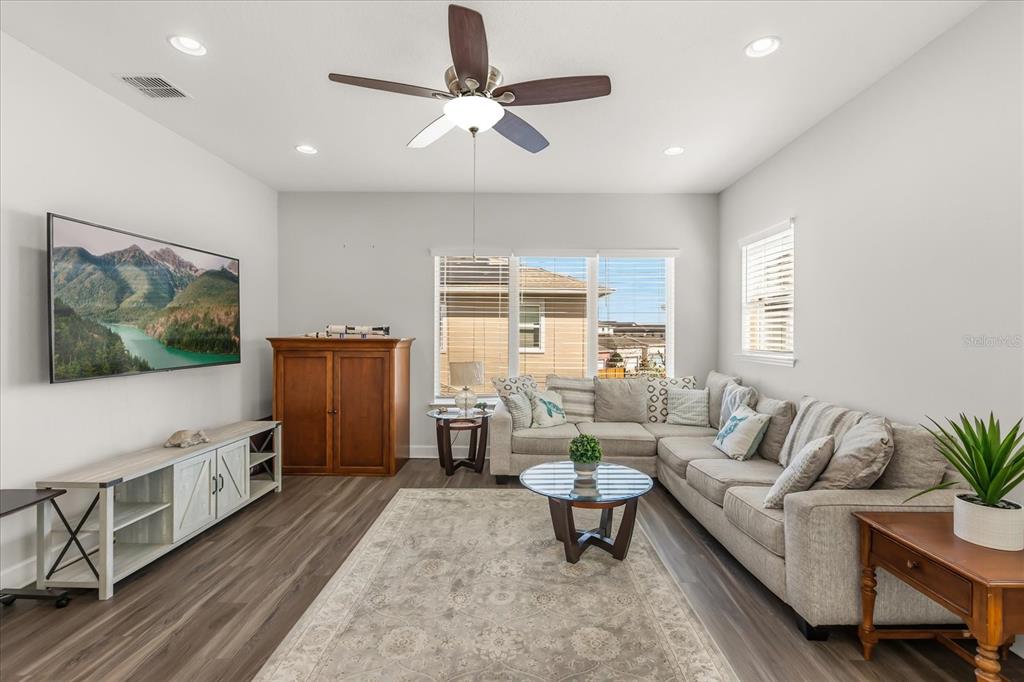A covered patio features a ping pong table on a rug and red-framed glass doors — 12837 BOVET AVENUE, ORLANDO, FL