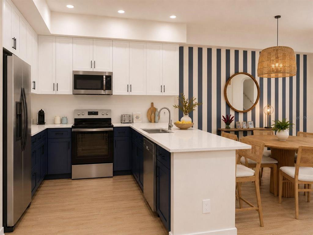 A kitchen with white upper cabinets, blue lower cabinets, and a striped accent wall — 131 TESSIE LANE, SANFORD, FL