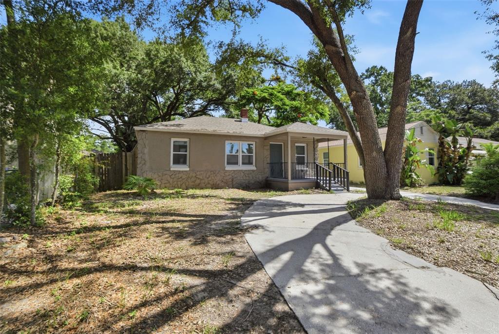 A single-story house with a stone-accented exterior and a front porch sits on a lot — 1416 E MOHAWK AVENUE, TAMPA, FL