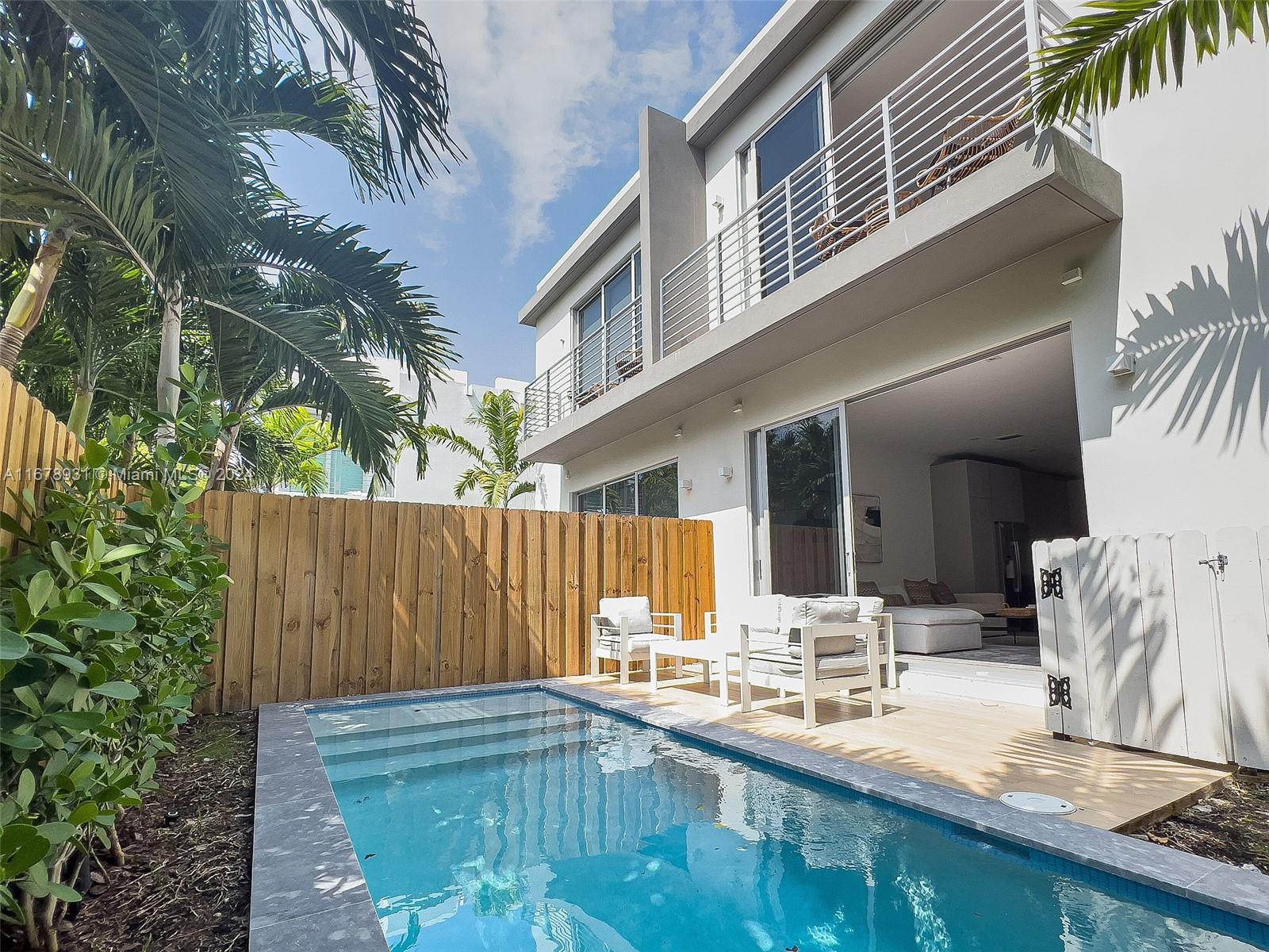 A modern two-story house with a small backyard pool and a wooden privacy fence — 3110 Elizabeth St # 3110, Miami FL 33133, MIAMI, FL