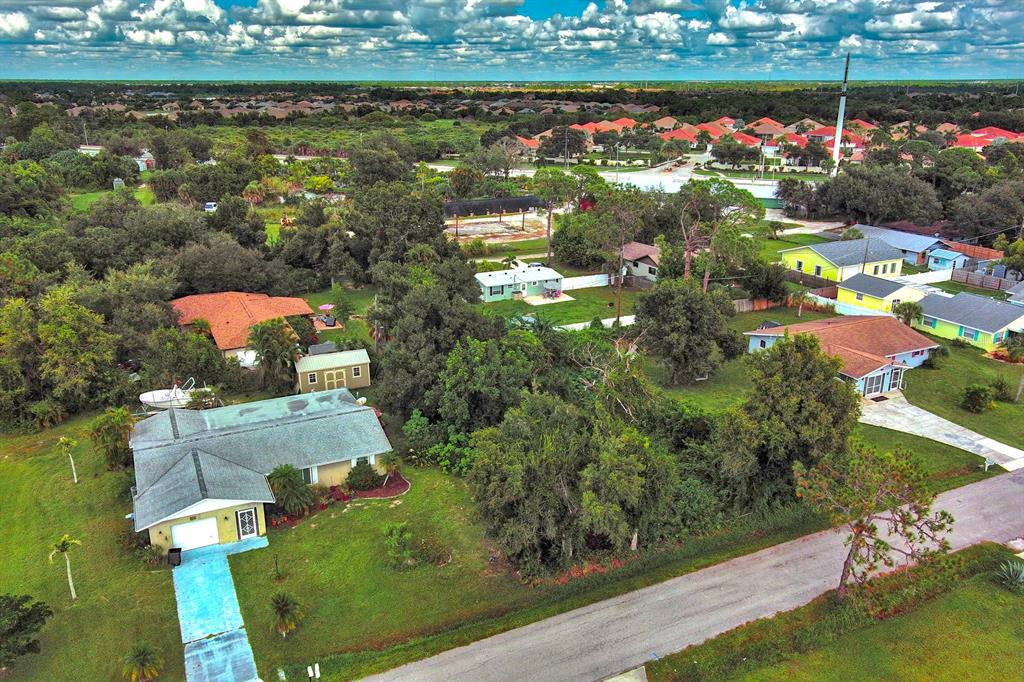 An aerial view shows a residential neighborhood with several houses, green lawns, and mature trees — GILLESPIE STREET, ENGLEWOOD, FL