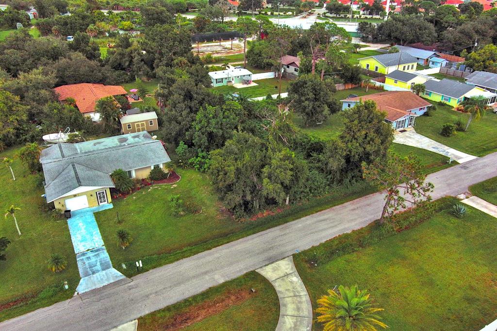 An aerial view shows a residential neighborhood with several houses, driveways, and surrounding trees — GILLESPIE STREET, ENGLEWOOD, FL
