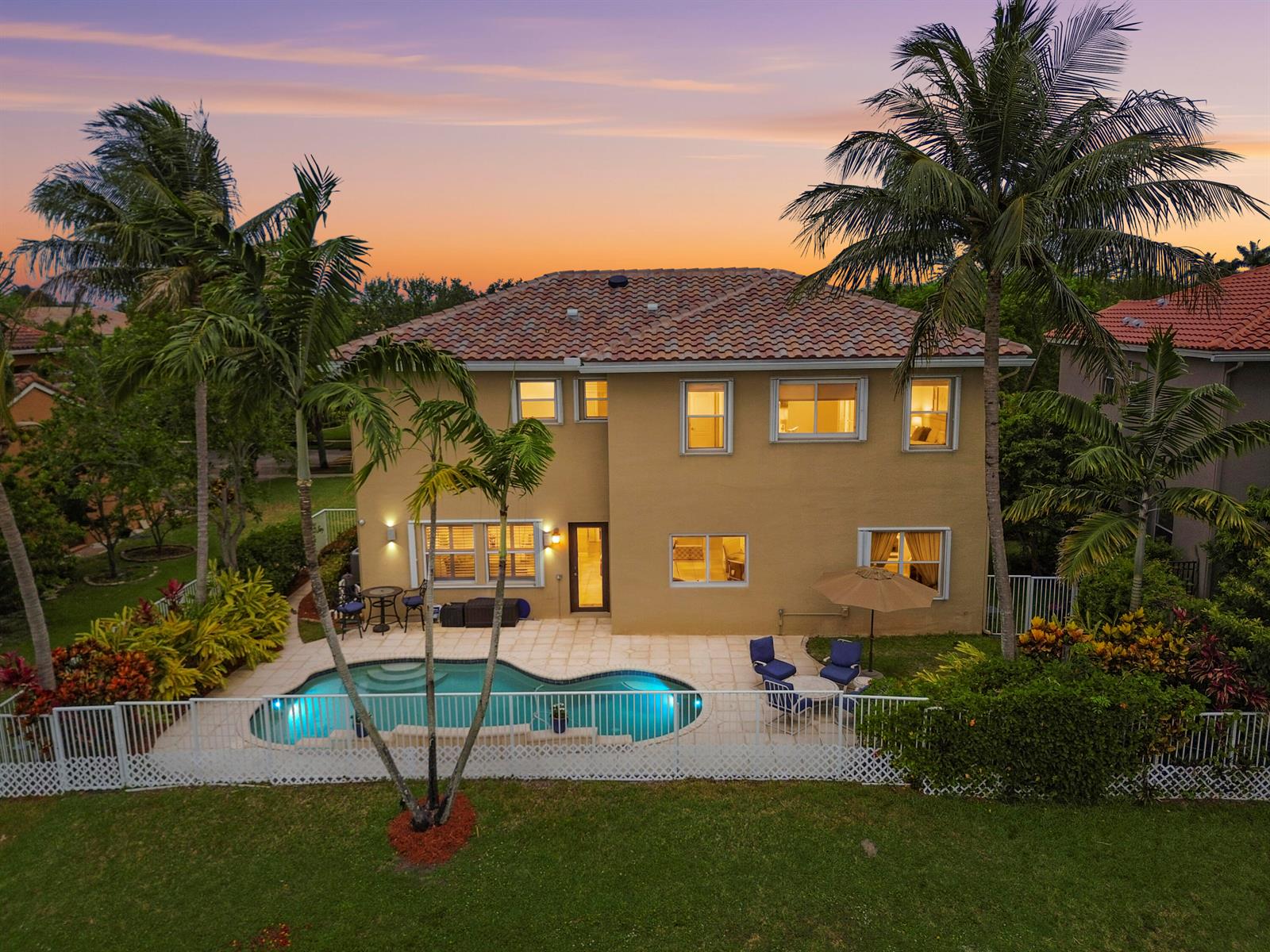 An aerial view of a two-story house with a backyard pool and palm trees — 458 Cresta Circle, West Palm Beach FL 33413, WEST PALM BEACH, FL