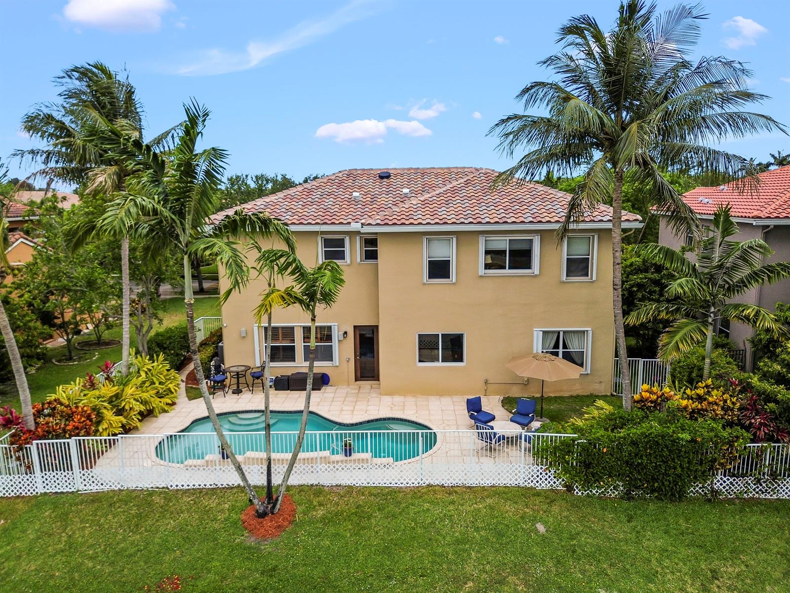An aerial view of a two-story house with a pool, patio, and palm trees — 458 Cresta Circle, West Palm Beach FL 33413, WEST PALM BEACH, FL