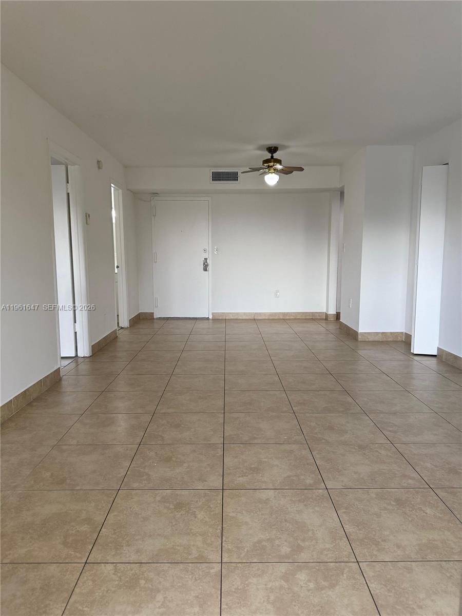 An empty room features beige floor tiles, white walls, and a ceiling fan — 4805 NW 7th St # 15, Miami FL 33126, MIAMI, FL