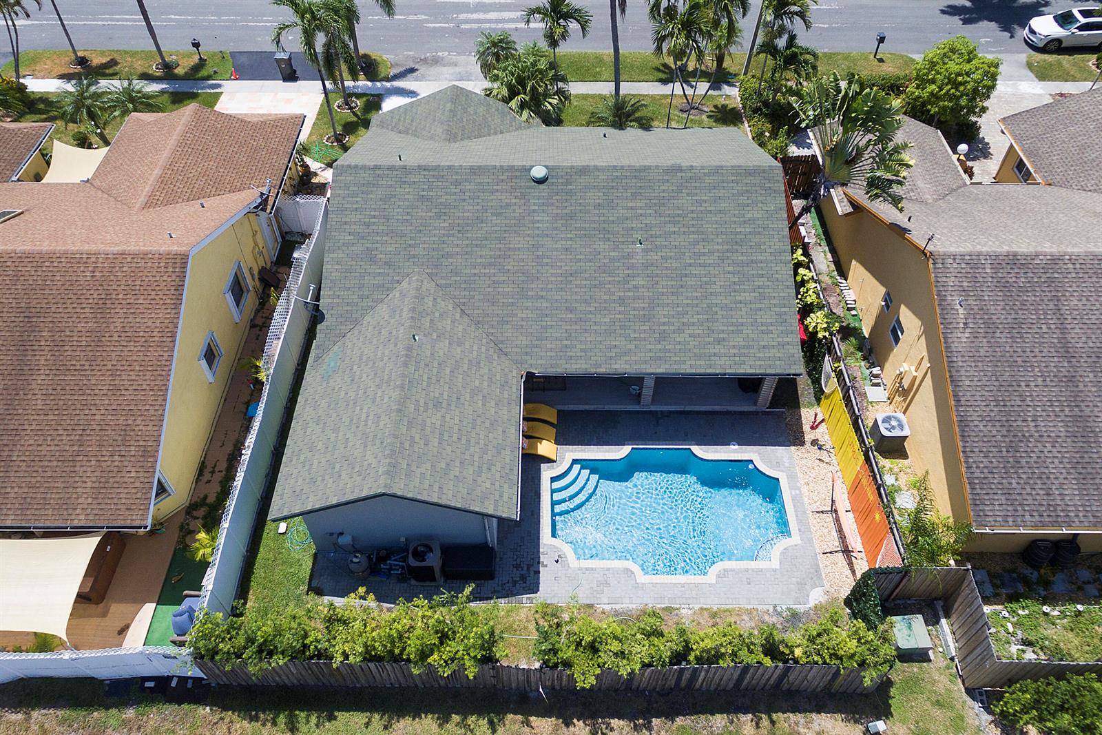 Aerial view of a house with a green roof, a swimming pool, and a fenced yard — 231 SE 8th Street, Dania Beach FL 33004, DANIA BEACH, FL
