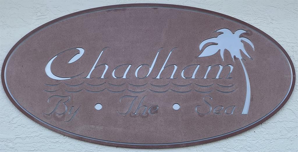 An oval sign on a textured wall reads Chadham By The Sea with a palm tree — 6727 TURTLEMOUND ROAD UNIT 416, NEW SMYRNA BEACH, FL