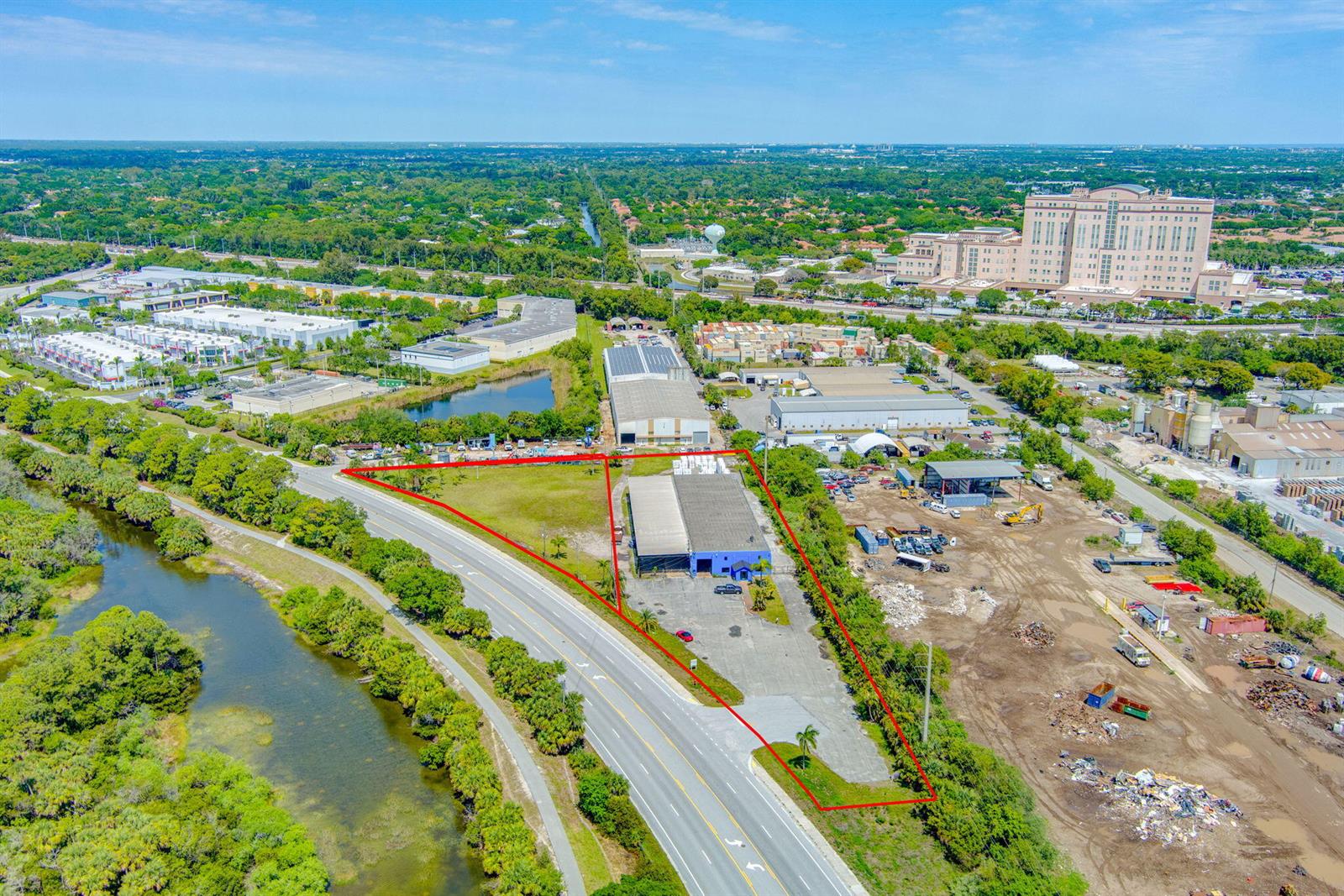 An aerial view shows a commercial property with a warehouse and parking lot outlined in red — 7030 Haverhill Road, Riviera Beach FL 33407, RIVIERA BEACH, FL