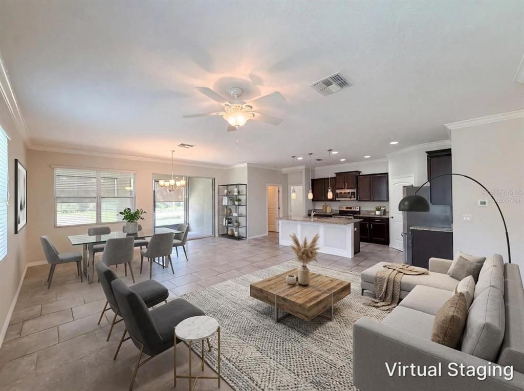 This virtually staged open-concept living and dining area features tile flooring and a modern kitchen — 5811 MARSH LANDING DRIVE, WINTER HAVEN, FL