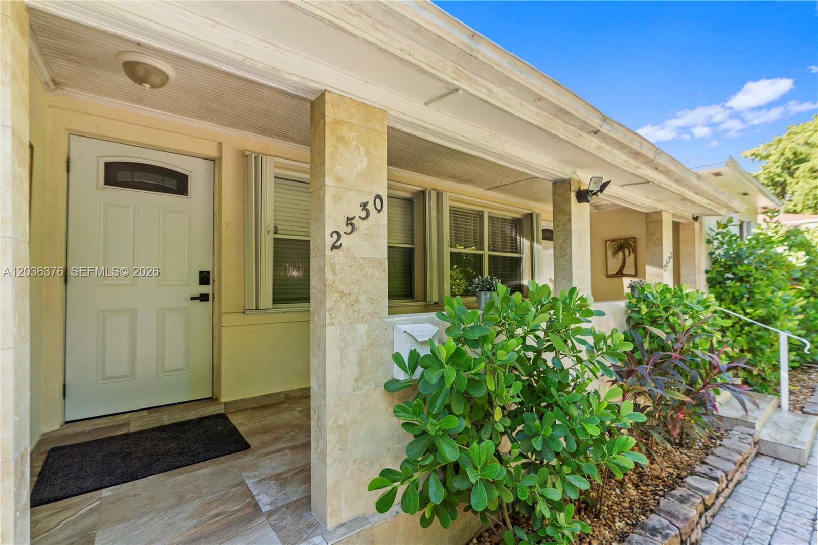 A covered front porch features a tiled pillar with house numbers and a white door — 2530 SW 27th St # 2532, Miami FL 33133, MIAMI, FL