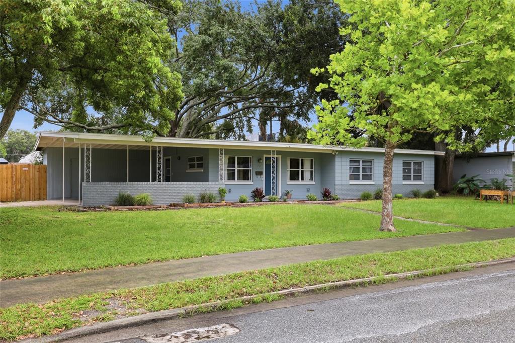 A single-story house with a gray exterior, a covered porch, and a large front lawn — 712 MALONE DRIVE, ORLANDO, FL