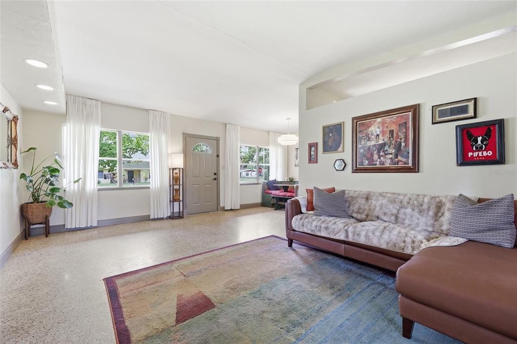 A living room with a brown sectional sofa, a patterned rug, and a front door — 712 MALONE DRIVE, ORLANDO, FL