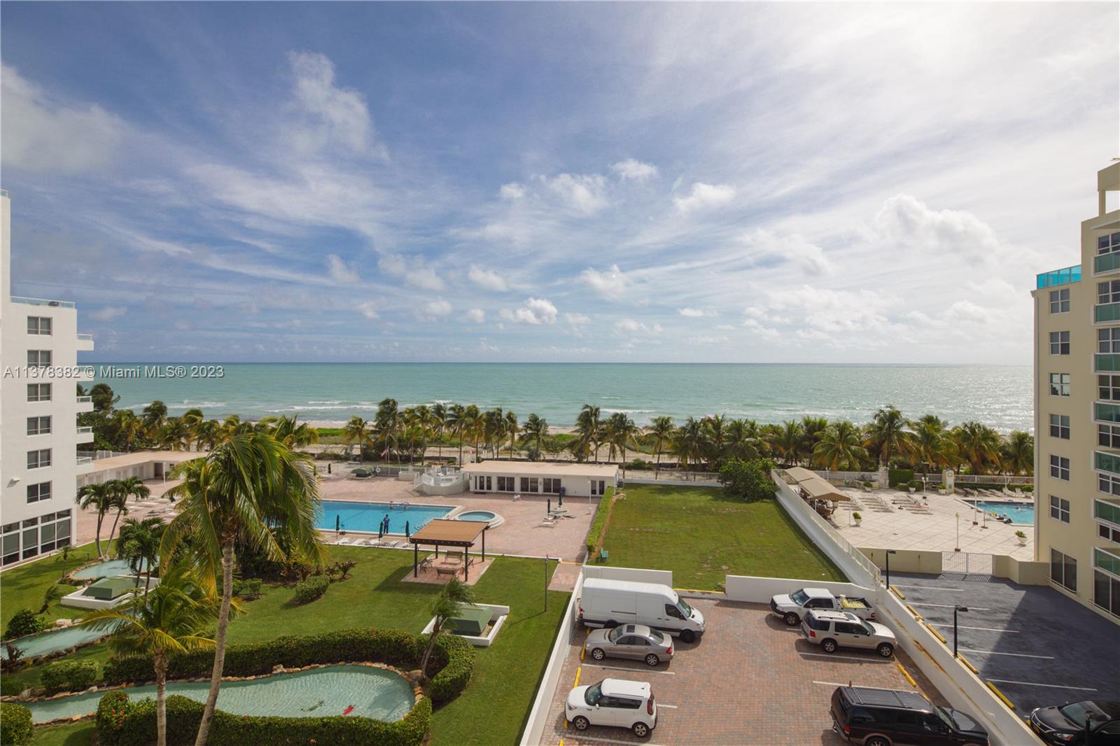 An elevated view shows a beachside property with swimming pools, palm trees, and a parking lot — 5005 Collins Ave # 610, Miami Beach FL 33140, MIAMI BEACH, FL