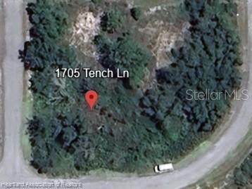 This is an aerial map view of a wooded, undeveloped residential lot — 1705 TENCH LANE, KISSIMMEE, FL