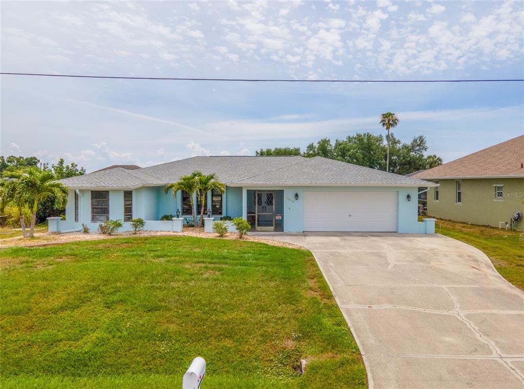 A light blue single-story house with a two-car garage and a concrete driveway — 3098 MAUCK TERRACE, PORT CHARLOTTE, FL