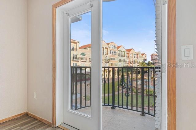 A view from inside a room through an open glass door onto a balcony — 101 PALM HARBOR PARKWAY UNIT C231- B, PALM COAST, FL