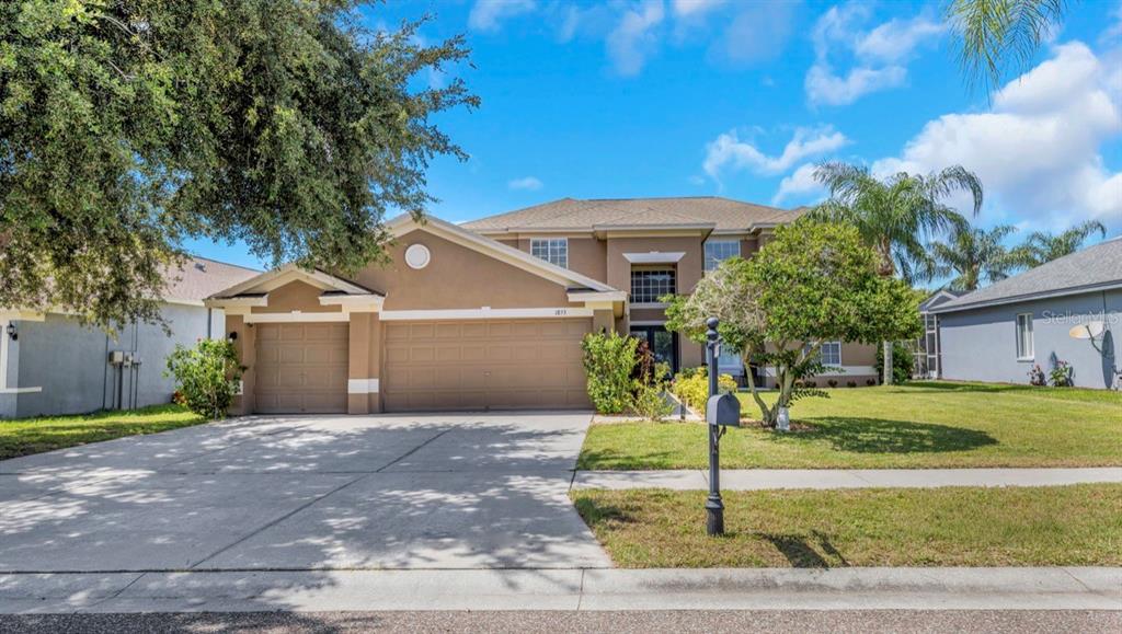 A two-story suburban house with a three-car garage and a concrete driveway — 1853 PINK GUARA COURT, NEW PORT RICHEY, FL