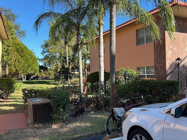 A white car is parked in front of a two-story peach and brick apartment building — 1925 SW Palm City Road # A, Stuart FL 34994, STUART, FL
