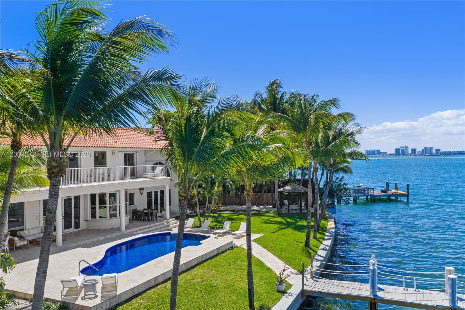 A two-story house with a pool, lawn, and private dock overlooks the bay — 1575 Stillwater Dr, Miami Beach FL 33141, MIAMI BEACH, FL
