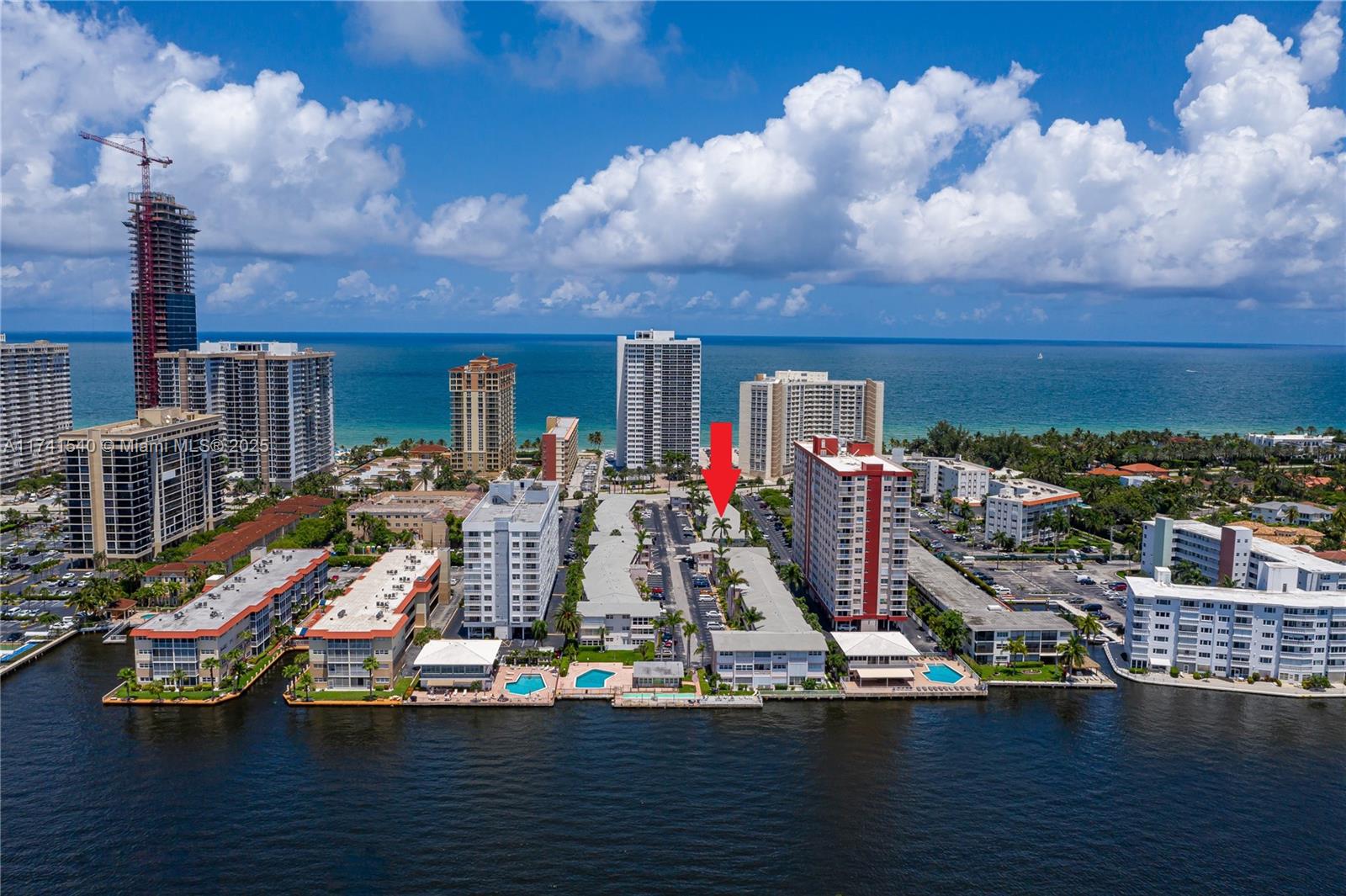 An aerial view shows a waterfront residential complex with multiple apartment buildings and swimming pools — 3131 S Ocean Dr # 211, Hallandale Beach FL 33009, HALLANDALE BEACH, FL
