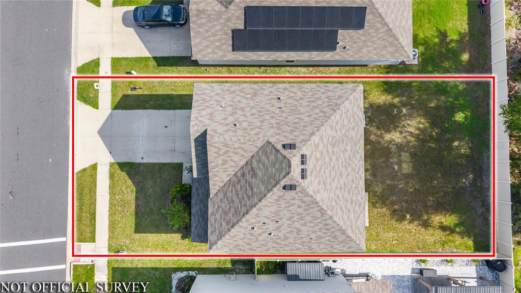 An aerial view shows a house with a shingled roof, driveway, and fenced backyard — 2143 NW 246TH TERRACE, NEWBERRY, FL