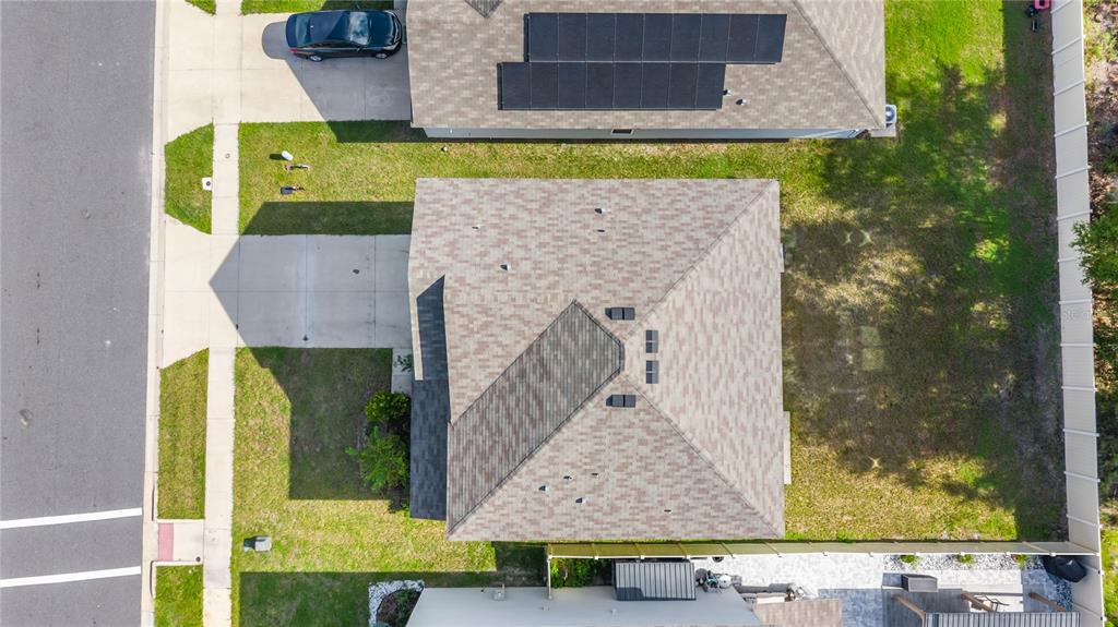 An aerial view shows a residential house with a shingled roof, driveway, and backyard — 2143 NW 246TH TERRACE, NEWBERRY, FL