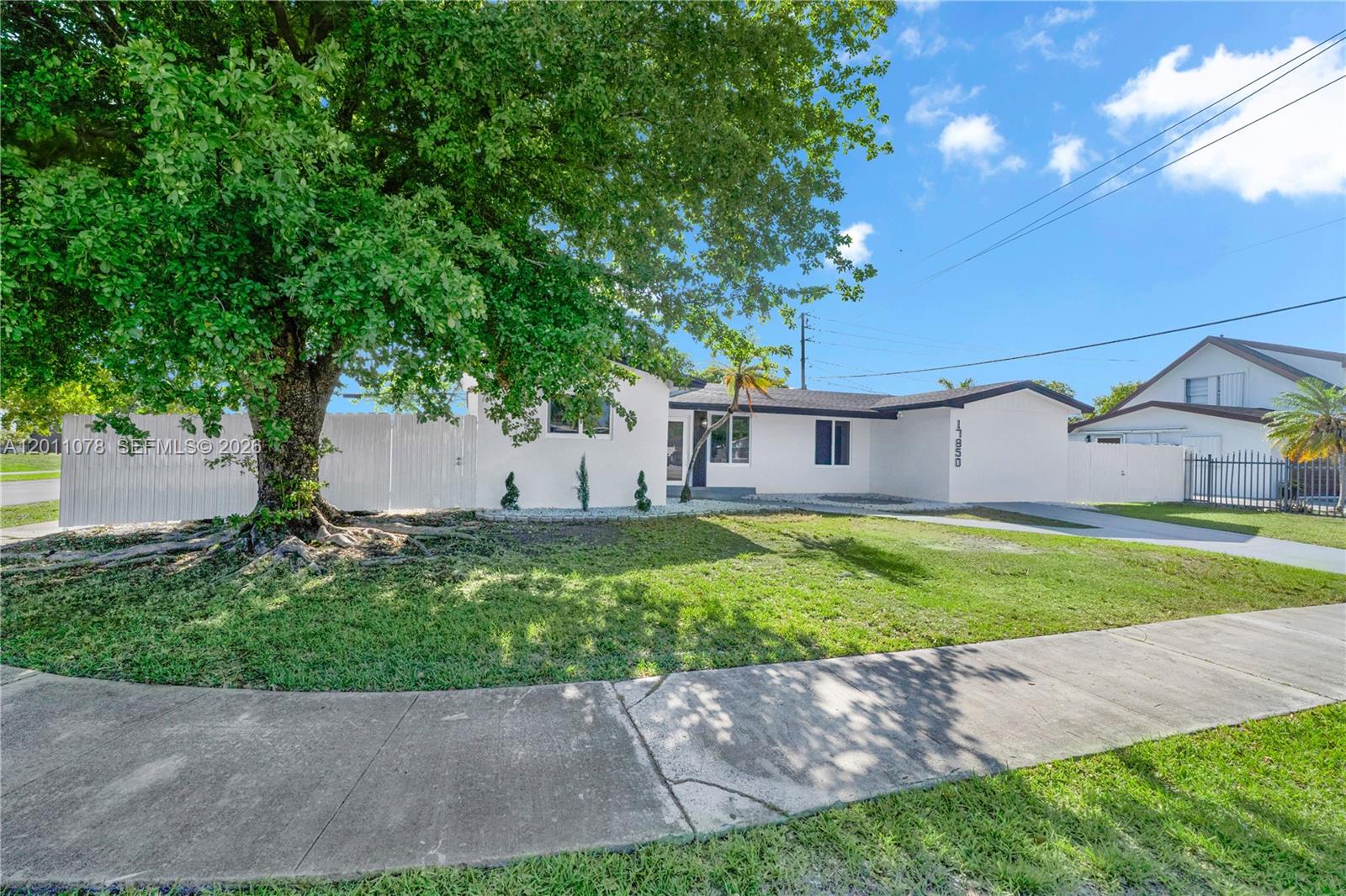 A single-story white house with a large tree in the front yard — 17850 SW 112th Ave, Miami FL 33157, MIAMI, FL
