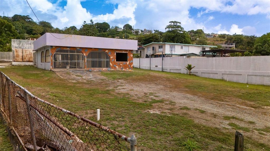 A single-story building with a flat roof and two gated garage bays sits on a lot — BO CATANO LOT #1 CARR 3 KM 85.9, HUMACAO, PR