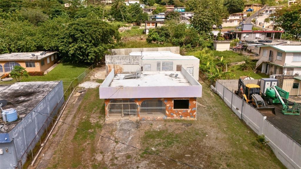 An aerial view of a single-story house with a flat roof and a gated facade — BO CATANO LOT #1 CARR 3 KM 85.9, HUMACAO, PR