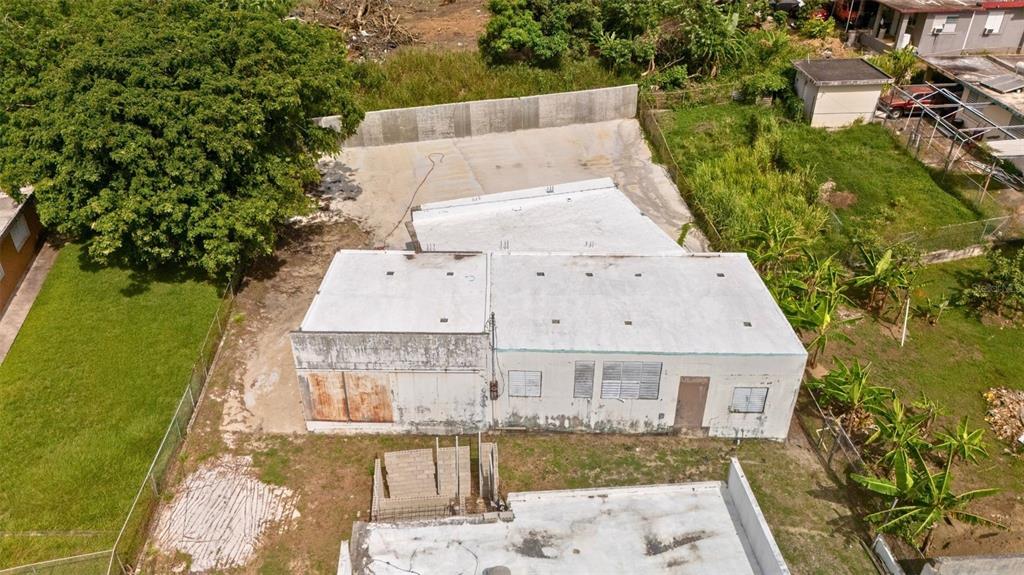 An aerial view shows a white, flat-roofed building with a concrete yard and surrounding vegetation — BO CATANO LOT #1 CARR 3 KM 85.9, HUMACAO, PR