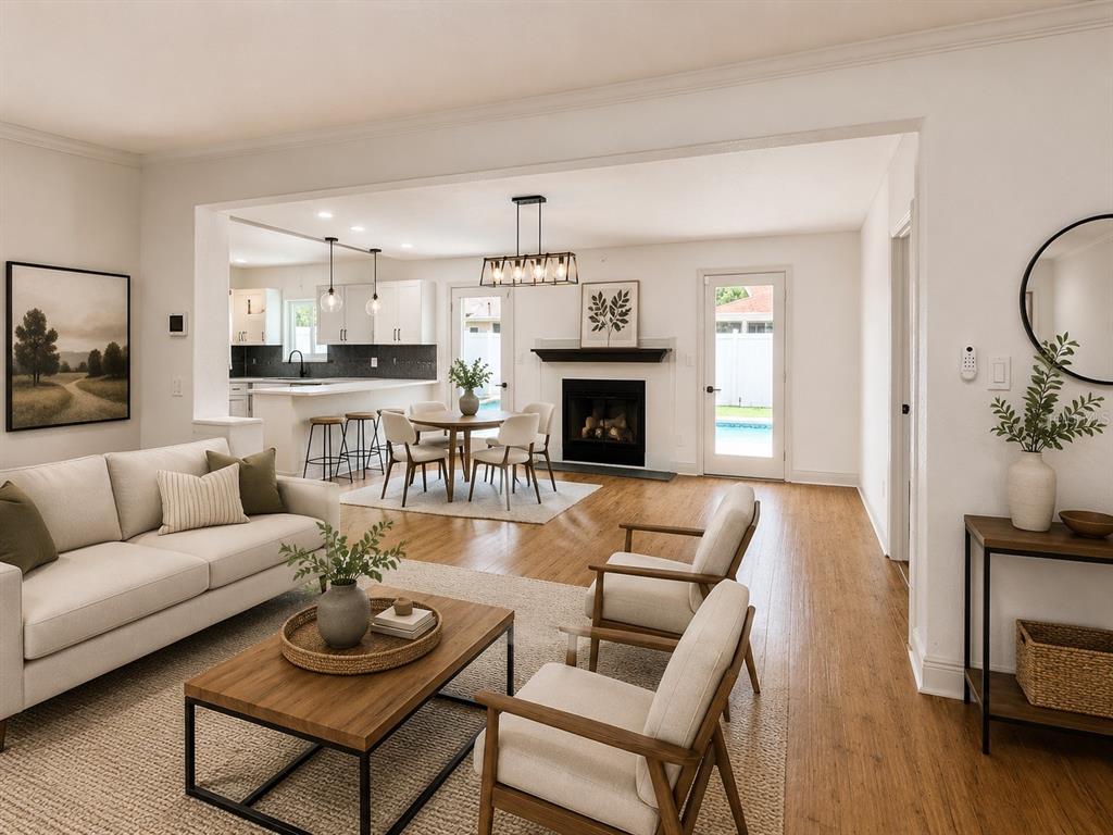 An open-concept living and dining area features light wood floors, a fireplace, and kitchen island — 9554 86TH AVENUE, SEMINOLE, FL