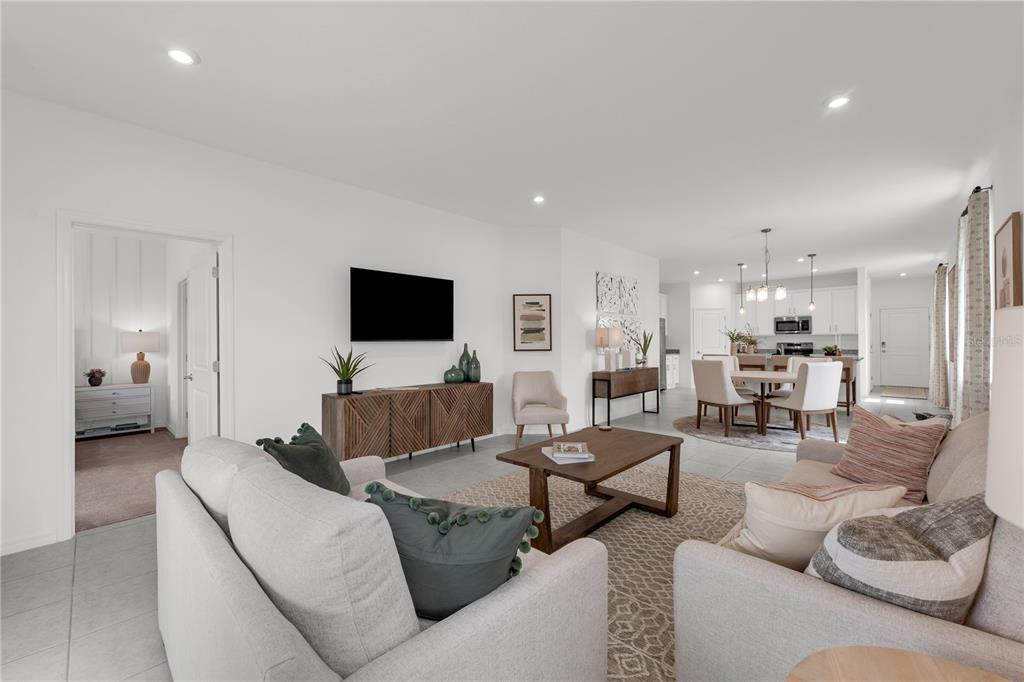An open-concept living room and dining area with light tile flooring and neutral walls — 936 CASTLEFORD AVENUE NE, PALM BAY, FL