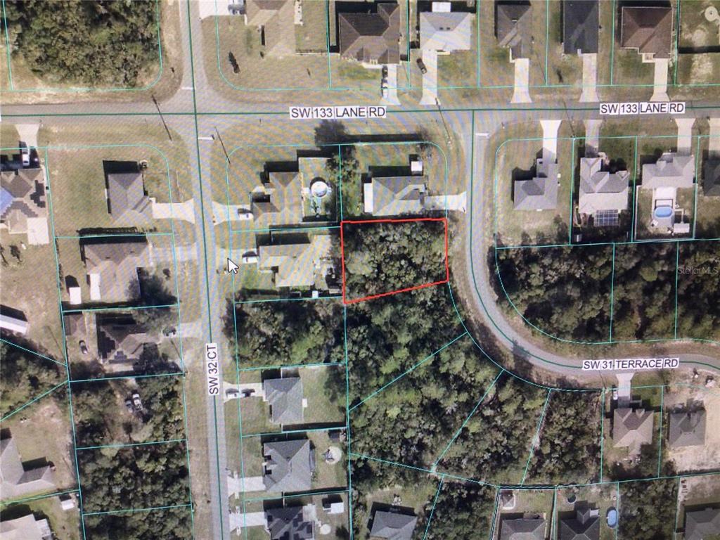 This aerial map shows a vacant, wooded residential lot outlined in red within a neighborhood — 0 SW 31 TERRACE ROAD, OCALA, FL