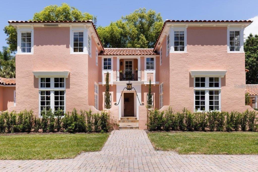 A two-story pink stucco house with a tiled roof and a central balcony entrance — 4511 BAY SHORE ROAD, SARASOTA, FL