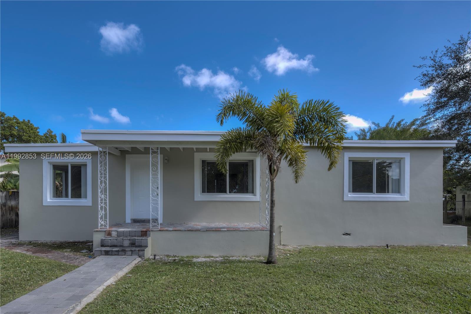 A single-story house with a light-colored exterior, a front porch, and a palm tree — 14115 NW 5th Ave # 1, Miami FL 33168, MIAMI, FL