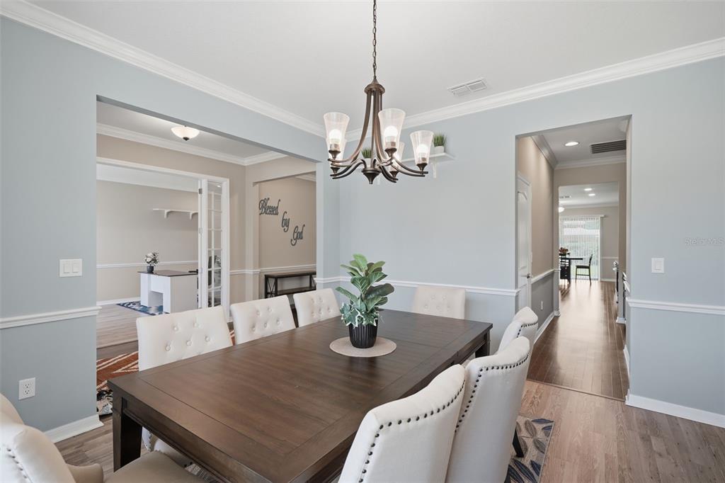 A two-story suburban house with a tan exterior, brown roof, and a paved driveway — 9307 PARISIAN COURT, SEFFNER, FL