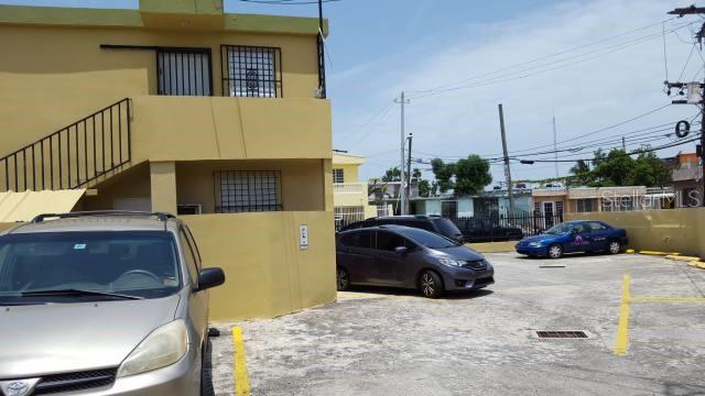 A yellow two-story building with an outdoor staircase and a paved parking lot in front — 404 ANDALUCIA, SAN JUAN, PR