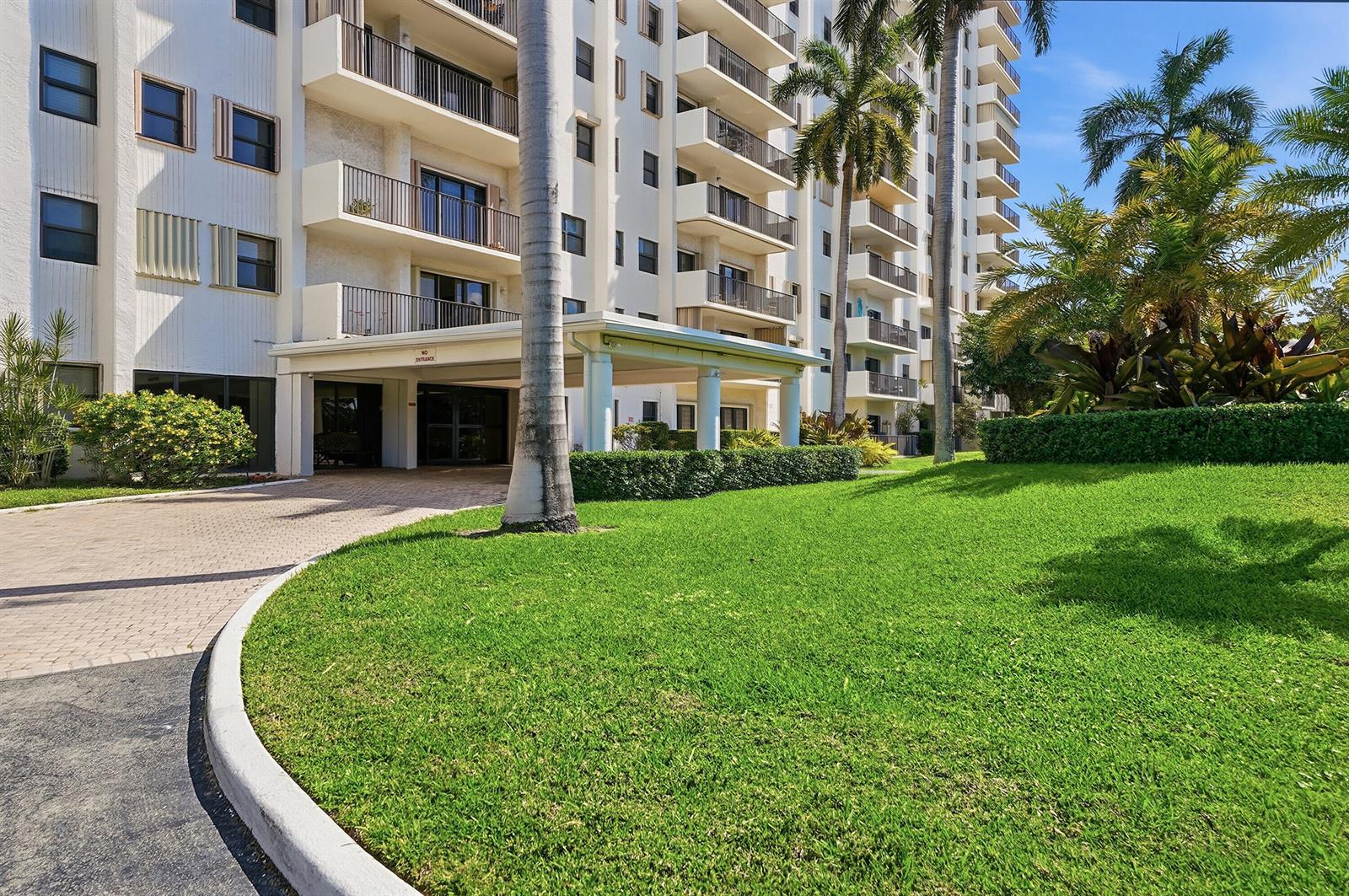 A multi-story residential building features balconies, a covered entrance, and a manicured lawn with palms — 1201 S Ocean Drive # 506s, Hollywood FL 33019, HOLLYWOOD, FL