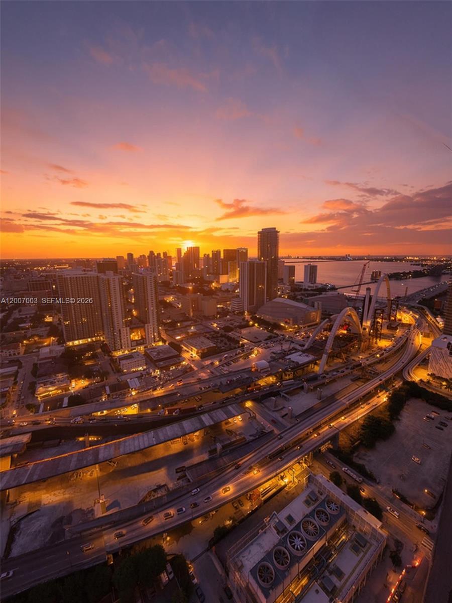 An aerial view of the Miami skyline at sunset featuring highways and high-rise buildings — 20 NE 11th St # 4202, Miami FL 33132, MIAMI, FL