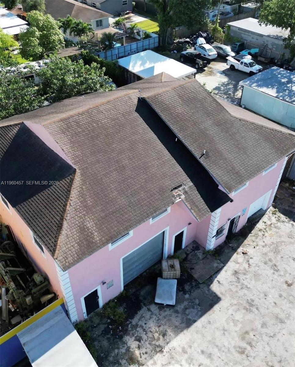 An aerial view shows a pink two-story building with a dark shingled roof — 3067 NW 54th St, Miami FL 33142, MIAMI, FL