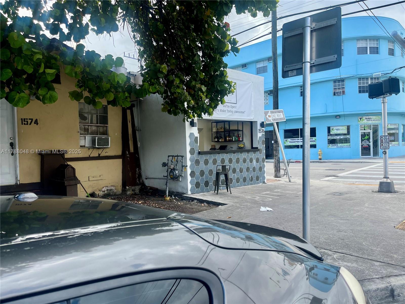 A small outdoor service window with a hexagonal tiled counter sits between two buildings — 1574 SW 1st St, Miami FL 33135, MIAMI, FL