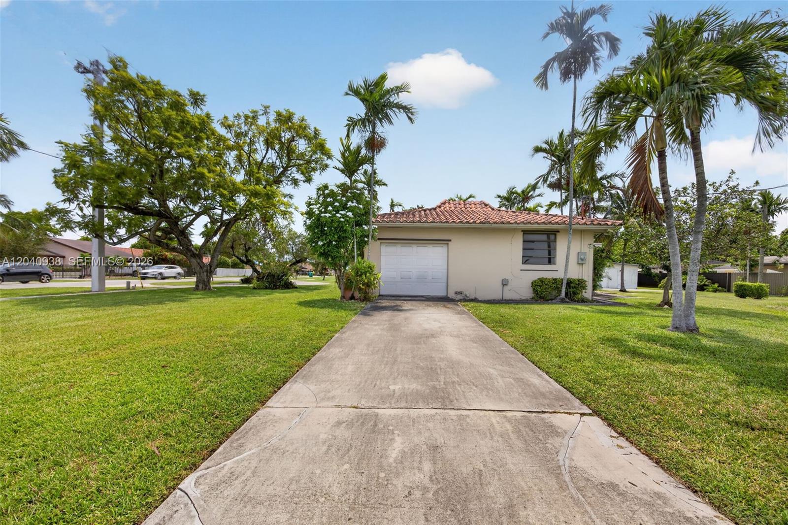 A single-story house with a tiled roof, a white garage door, and a concrete driveway — 11405 SW 32nd St, Miami FL 33165, MIAMI, FL
