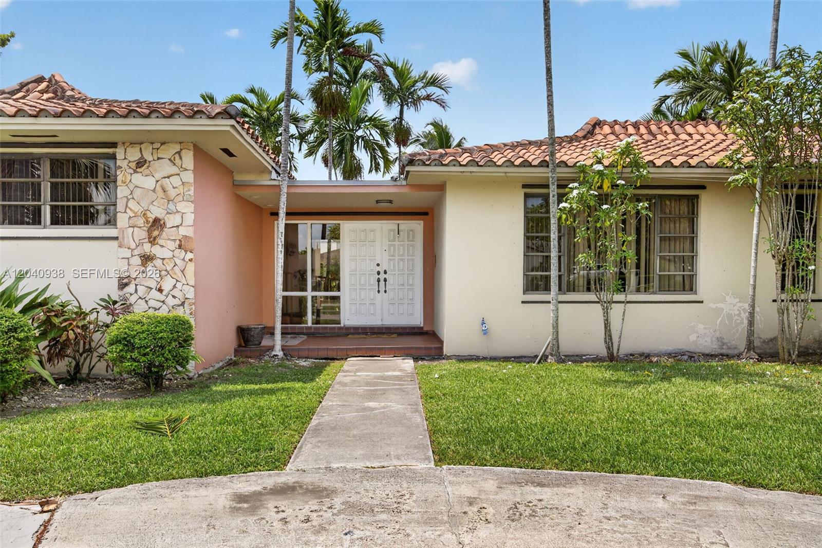 A single-story house features a stone-accented facade, a tiled roof, and a central entryway — 11405 SW 32nd St, Miami FL 33165, MIAMI, FL