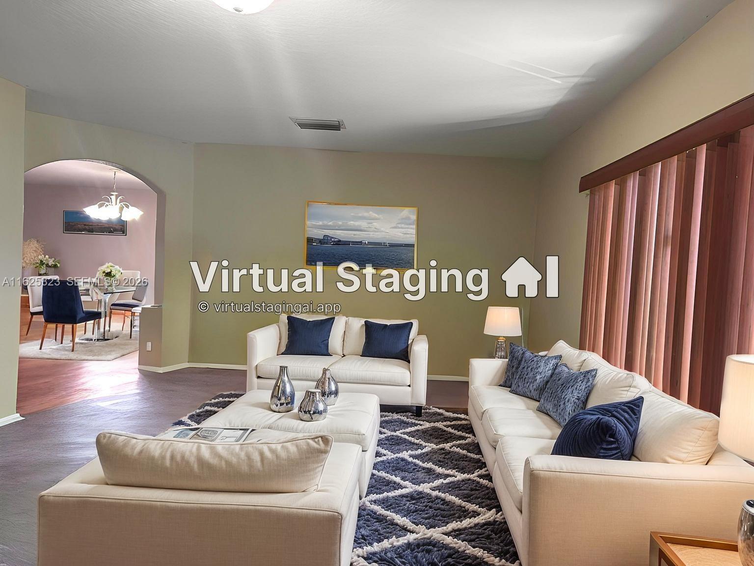 This living room features white sofas, a patterned rug, and an arched entryway to dining — 12414 SW 213th St, Miami FL 33177, MIAMI, FL
