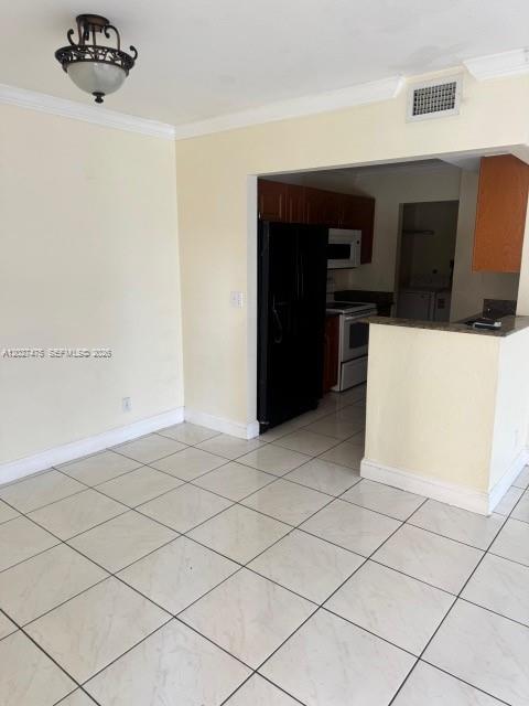 A dining area with tiled floors leads into a kitchen with dark wood cabinets — 2850 NW 55th Ave # 1D, Lauderhill FL 33313, LAUDERHILL, FL