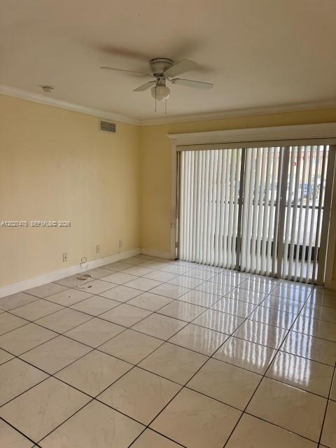 An empty room features light-colored tile flooring, a ceiling fan, and vertical window blinds — 2850 NW 55th Ave # 1D, Lauderhill FL 33313, LAUDERHILL, FL